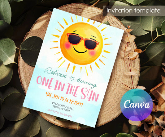 One in the Sun Sunglasses First Birthday Invitation - Editable 5×7; invitation lying on a wooden tabletop.